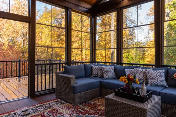 Cozy screened patio in early morning, rain drops on window.